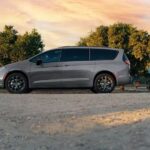 A gray 2024 Chrysler Pacifica is shown parked near a picnic bench.