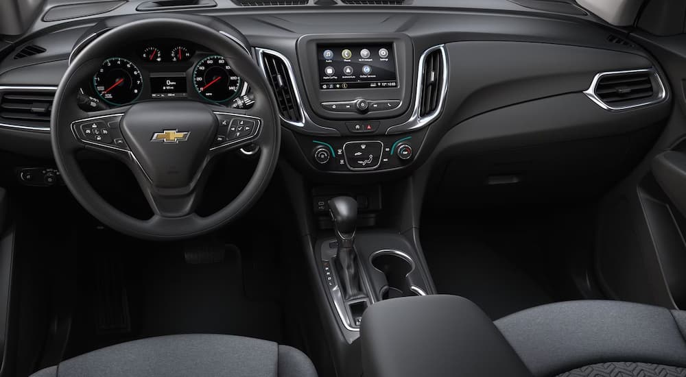 The steering wheel and dashboard in a 2024 Chevy Equinox LS for sale.