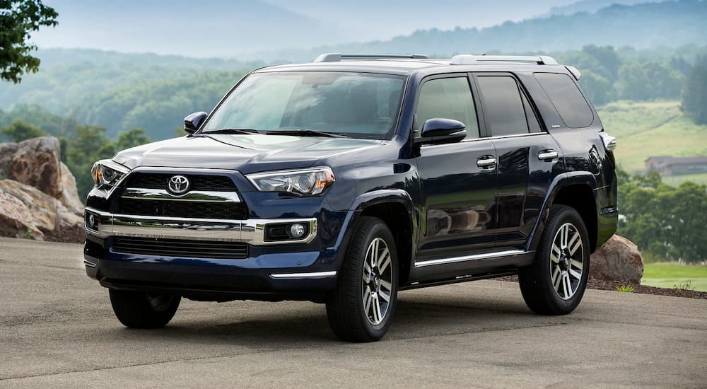 A used SUV for sale, a blue 2018 Toyota 4Runner Limited, parked in the mountains.