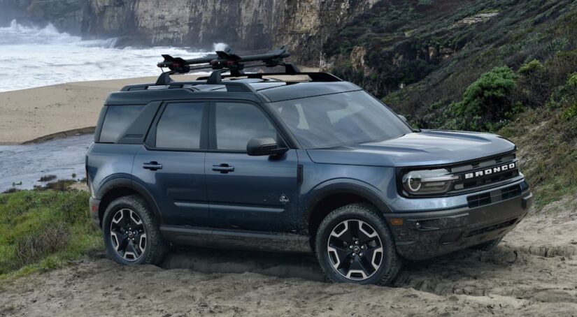 A blue 2021 Ford Bronco Sport is shown parked off-road after viewing used SUVs for sale.