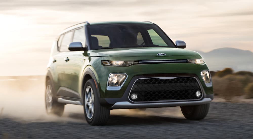 A green 2021 Kia Soul is shown driving off-road.
