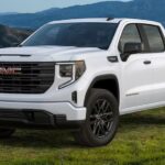 A popular GMC Sierra 1500 for sale, a white 2024 GMC Sierra 1500 SLE, is shown parked on grass.