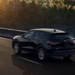 A black 2024 Honda HR-V LX is shown driving on a bridge after viewing a Honda HR-V for sale.