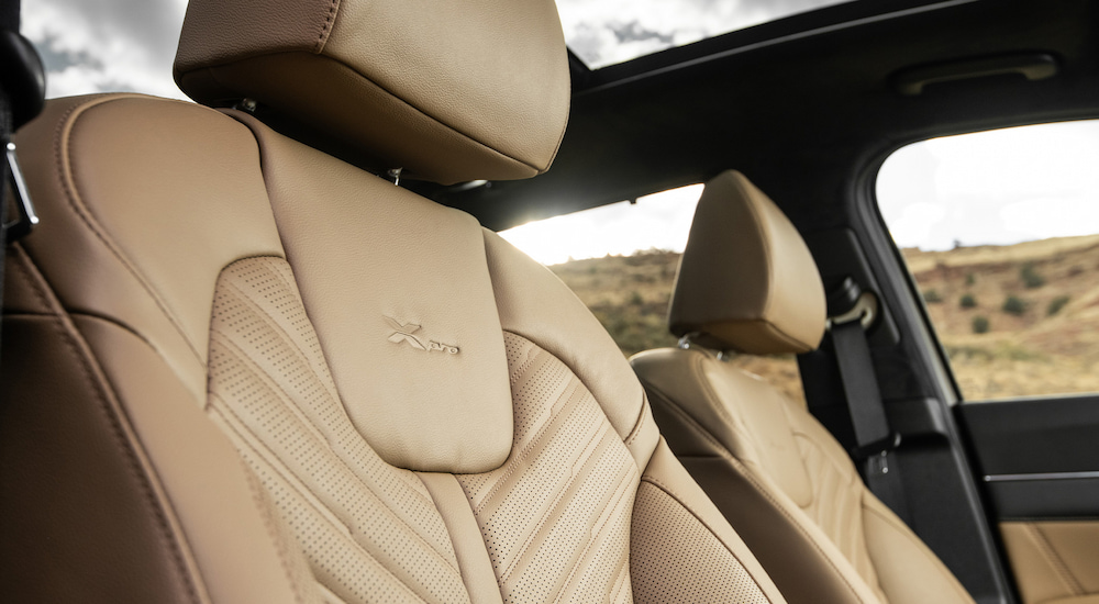 The tan leather upholstery and embossed X-Pro emblem in a 2024 Kia Sorento X-Pro SX Prestige.
