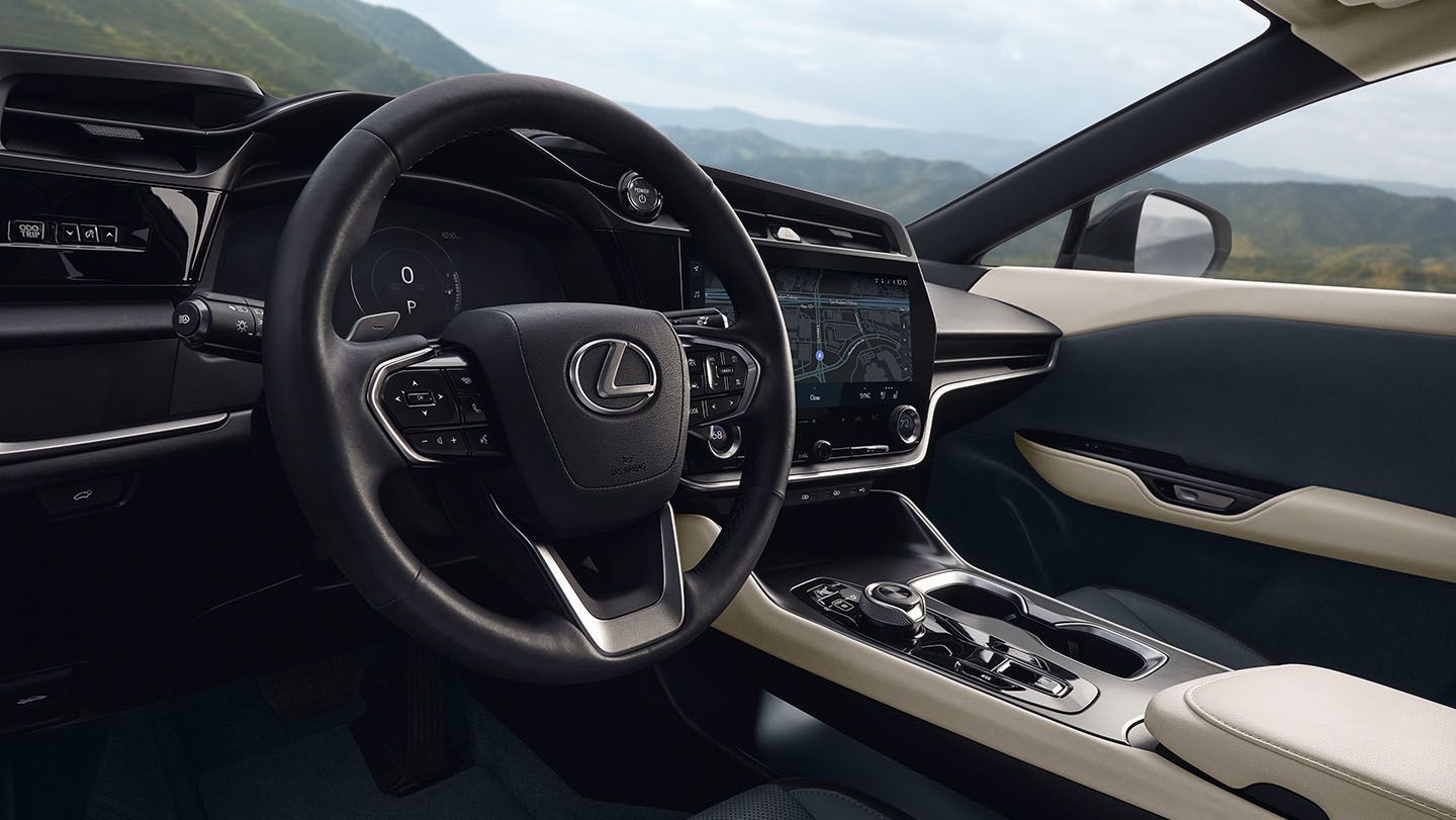 The black and beige interior of a 2024 Lexus RZ for sale at a Lexus dealer.