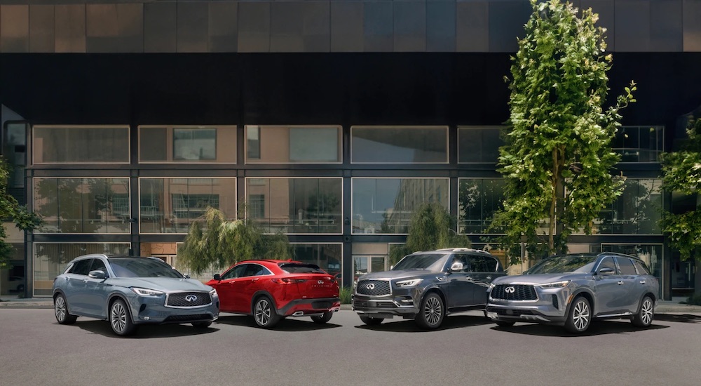A row of 2025 Infiniti luxury SUV models parked outside a building.