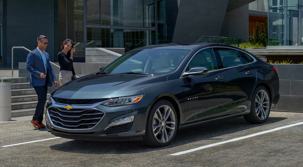 A gray 2019 Chevy Malibu is shown parked on a parking spot.