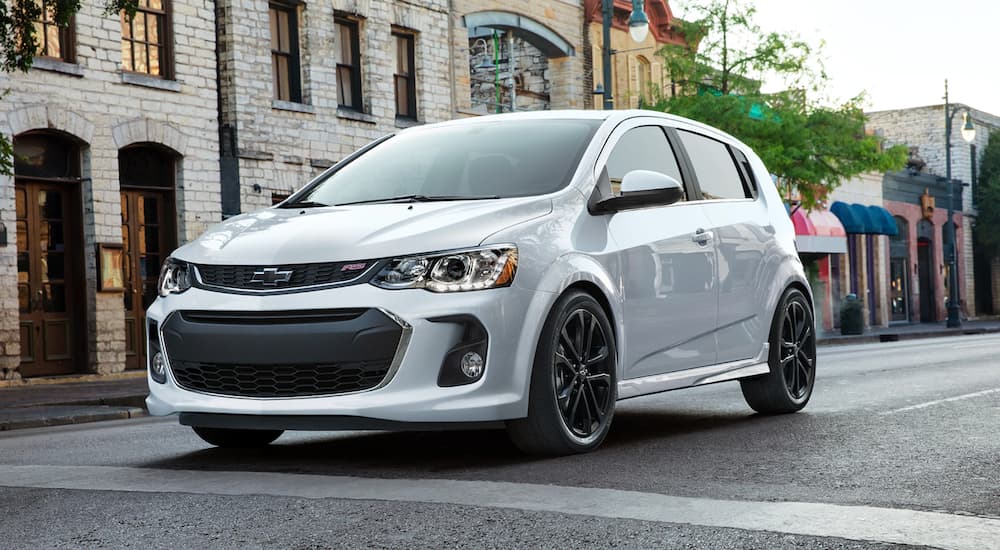 A white 2020 Chevy Sonic Rs is shown stopped near a crosswalk.