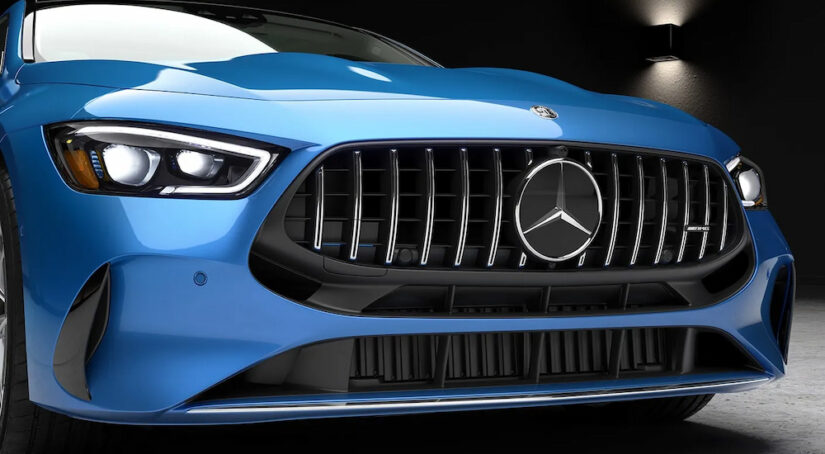 A close-up of the grille and headlights on a blue 2024 Mercedes-Benz AMG GT Coupe.