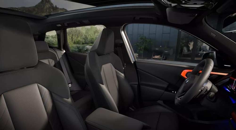 The black and gray interior in a 2025 BMW X3 30 xDrive is shown.