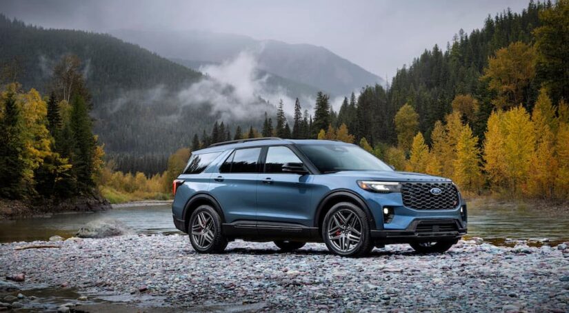 A blue 2025 Ford Explorer is shown parked off-road after leaving a dealer that has a used Ford Explorer for sale.