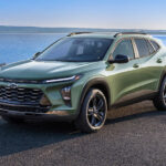 A green 2025 Chevy Trax ACTIV parked near water.