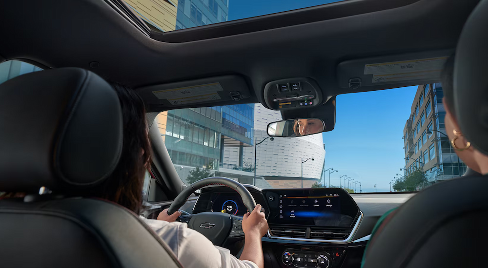 The infotainment screen and moonroof in a 2025 Chevy Trax for sale.