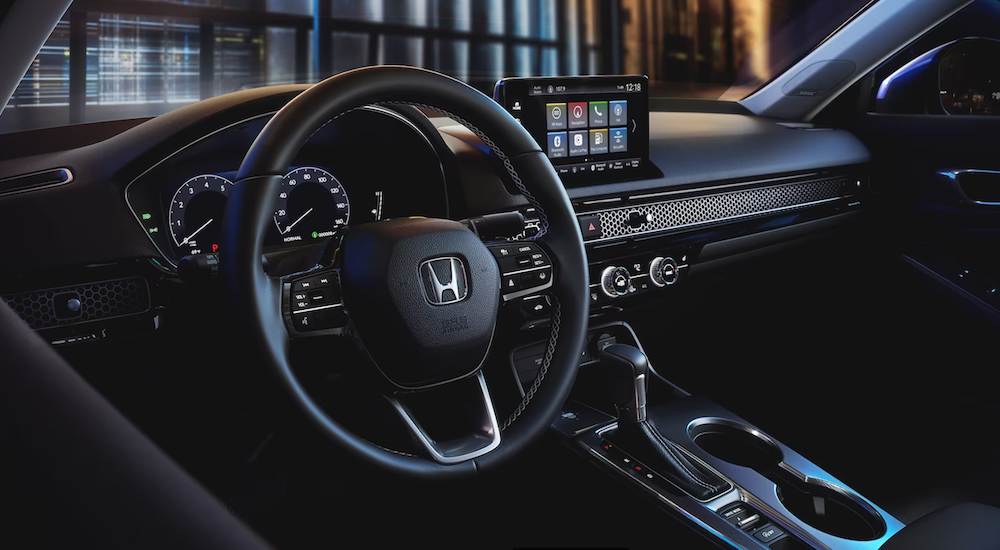 The black wheel and dashboard of a 2024 Honda Civic.