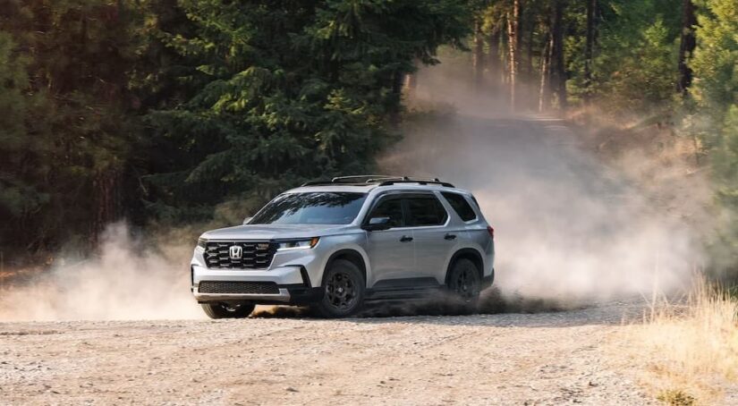 A silver 2025 Honda Pilot is shown from the front at an angle.