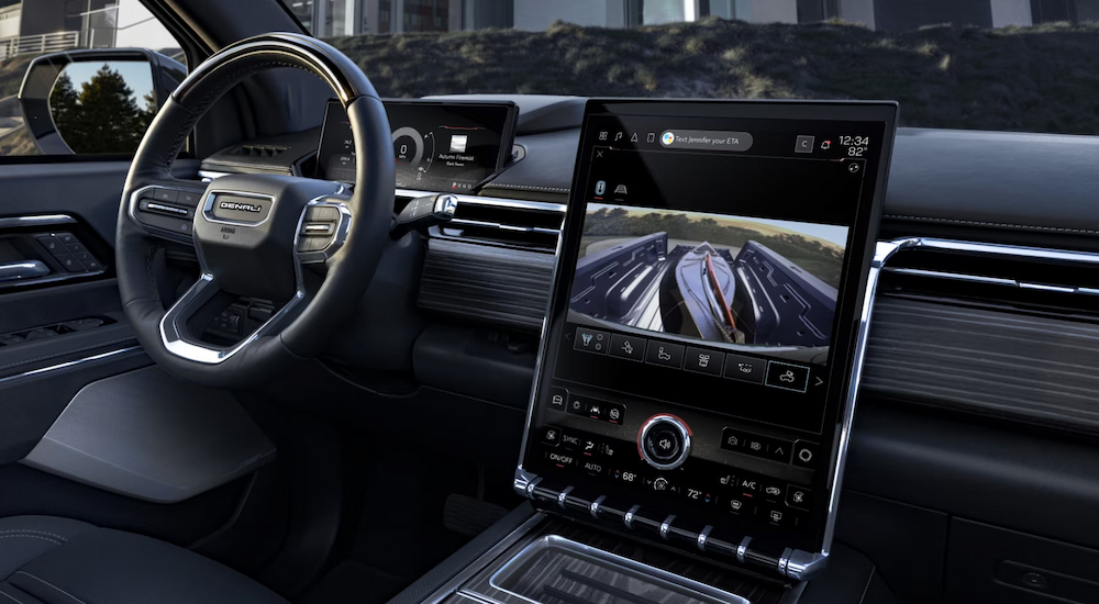 The infotainment screen and steering wheel in a 2024 GMC Sierra EV Denali Edition 1.