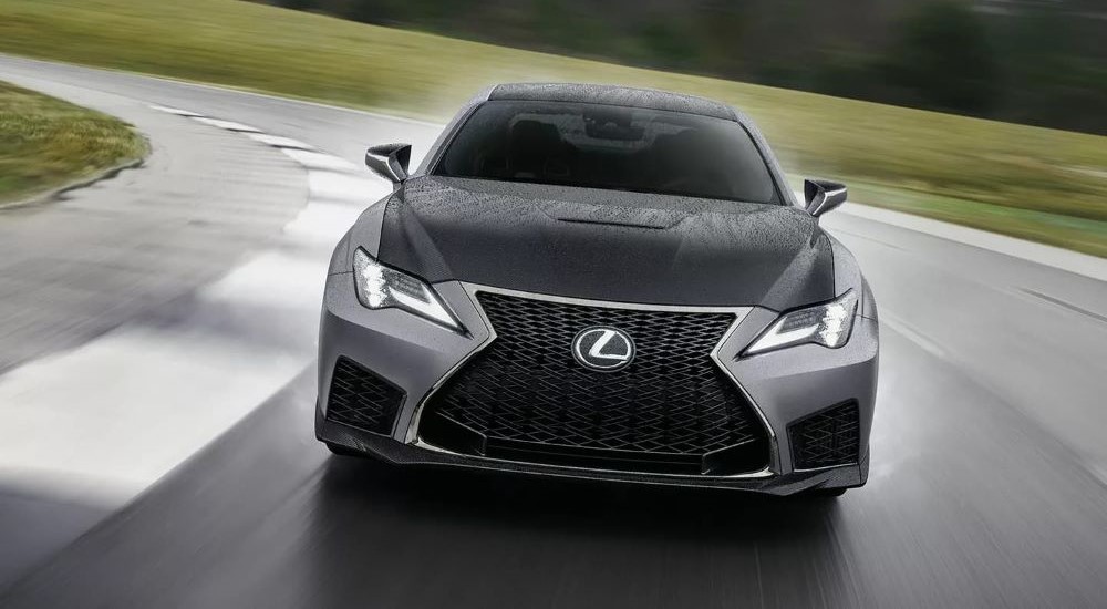 A black and gray 2023 Lexus RC F is shown driving on a racetrack.