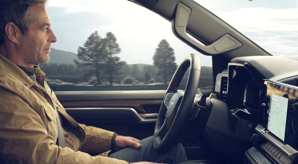 A person is shown utilizing Super Cruise in a 2024 Chevy Silverado 1500 after viewing a used Chevy Silverado for sale near San Antonio.