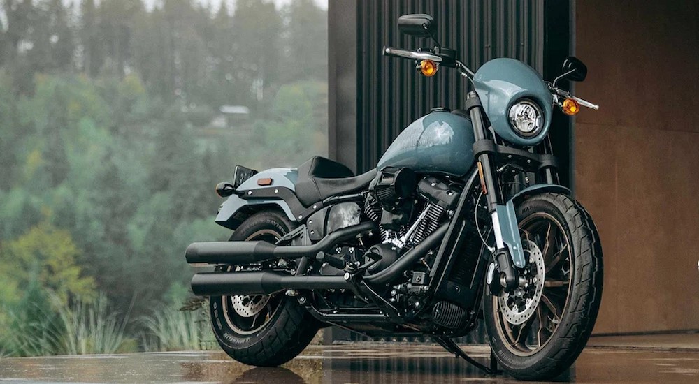 A blue 2024 Harley-Davidson Low Rider S is shown parked on a rainy day.