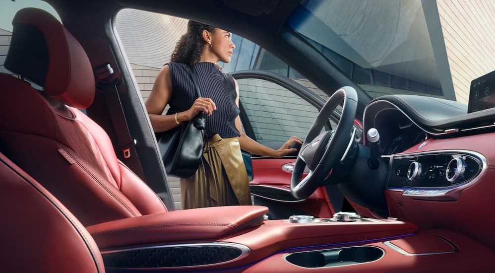 The red and black interior and dash in a 2025 Genesis GV70 is shown.