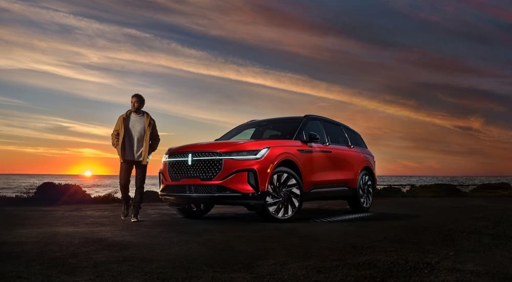 A red 2025 Lincoln Nautilus is shown parked near an ocean.