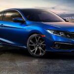 A blue 2020 Honda Civic Sport Coupe is shown from the front at an angle after leaving a dealer that has a used Honda Civic for sale.