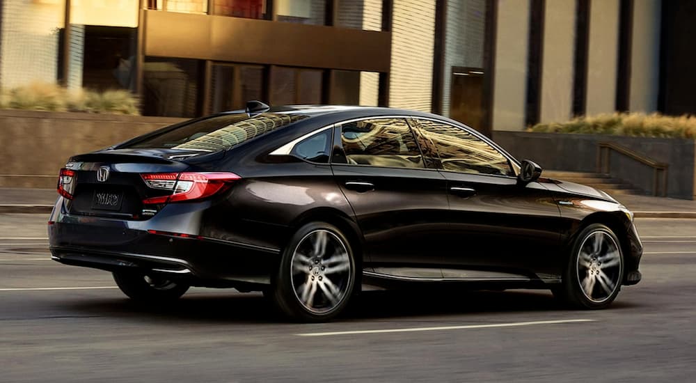 A black 2021 Honda Accord is shown from the rear at an angle.