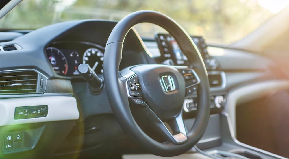 The interior of a 2021 Honda Accord is shown from the driver's door opening.