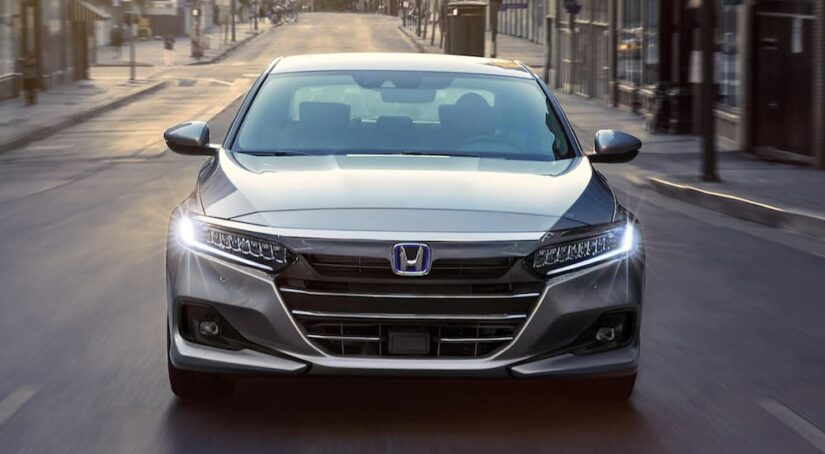 A grey 20212 Honda Accord is shown from the front at an angle after leaving a dealer that has a used Honda Accord for sale.