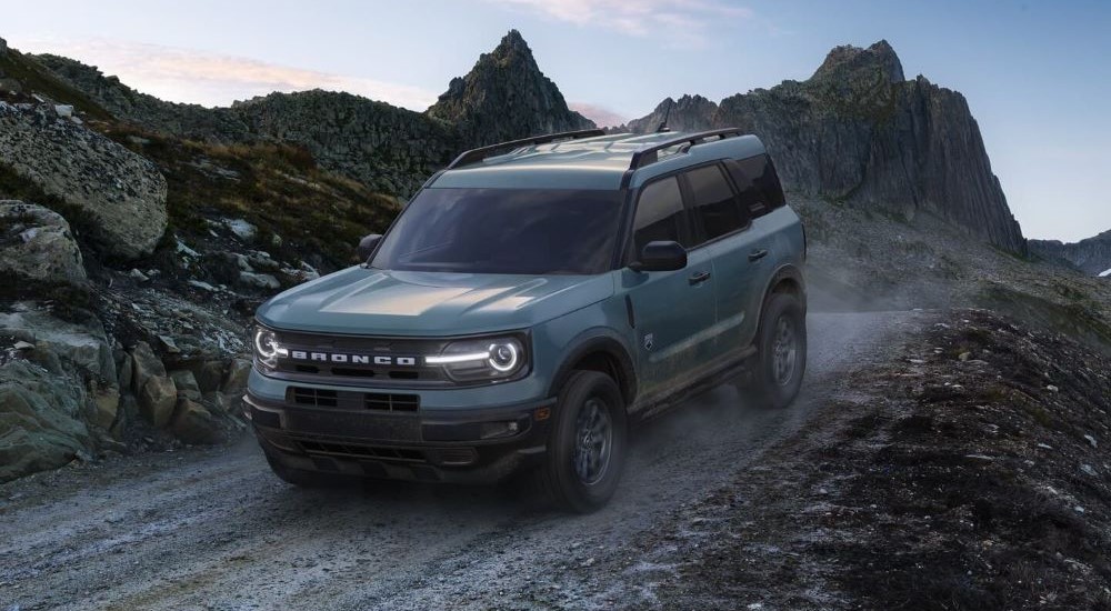 A blue 2024 Ford Bronco Sport Big Bend is shown driving off-road.