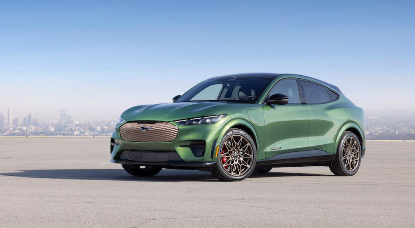 A green 2024 Ford Mustang Mach-E GT is shown from the side.