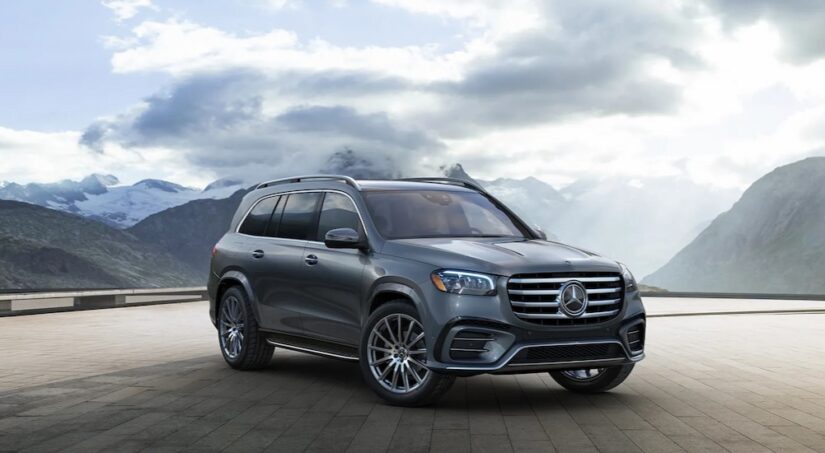 A gray 2024 Mercedes-Benz GLS is shown parked near a Mercedes-Benz dealer.