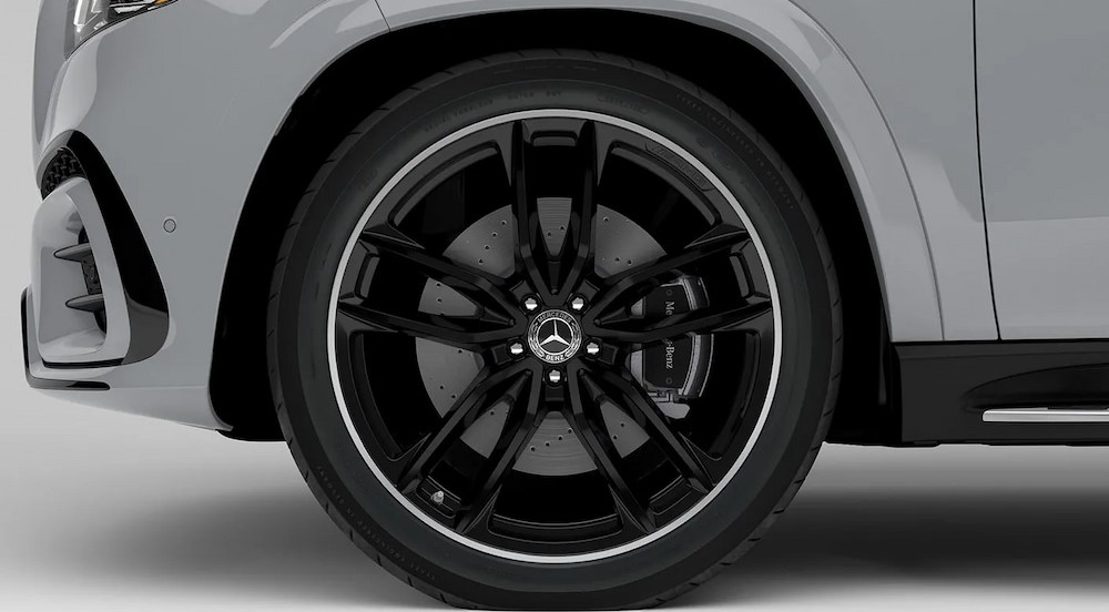 A close-up of a wheel on a gray 2024 Mercedes-Benz GLS is shown.