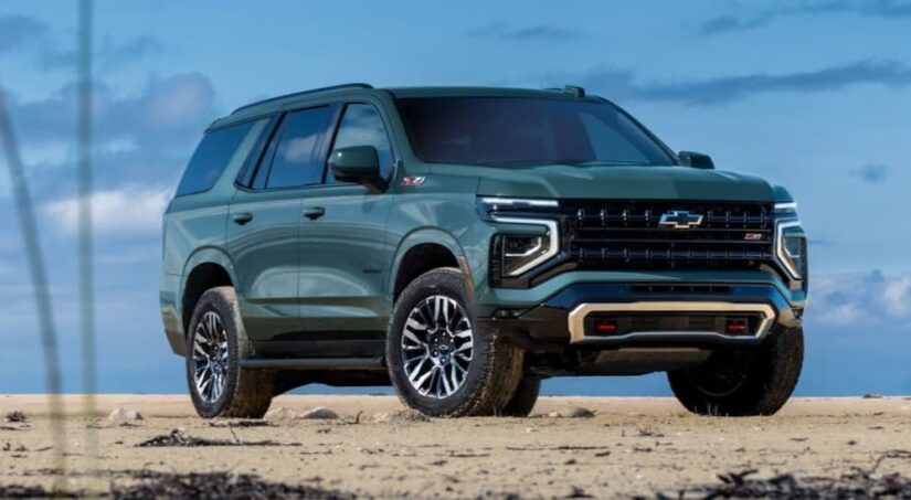 A green 2025 Chevy Tahoe Z71 is shown parked off-road.