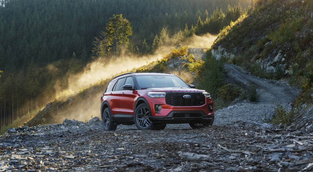 A red 2025 Ford Explorer parked off-road and angled right. 