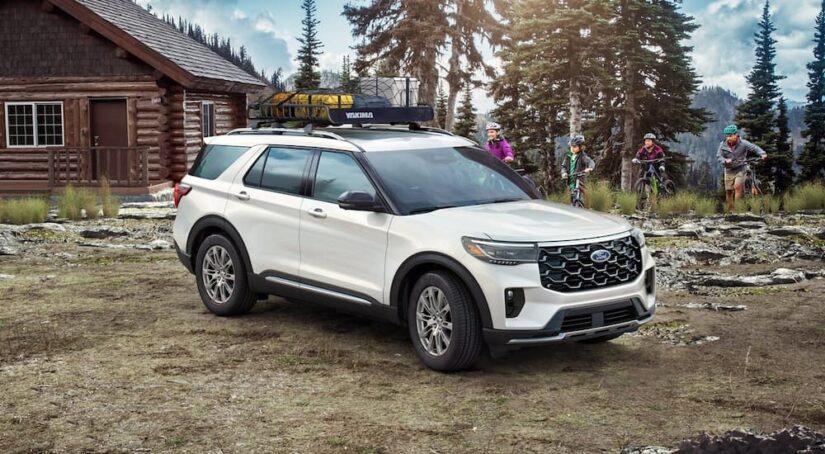 A white 2025 Ford Explorer parked outside a building.