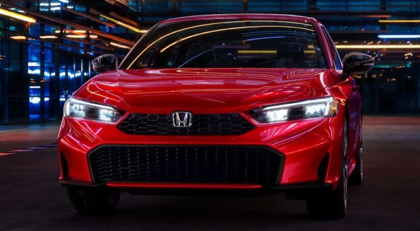 A close-up on the hood and grille of a red 2025 Honda Civic Sedan.