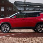 A side angle view of a red 2024 Jeep Compass.