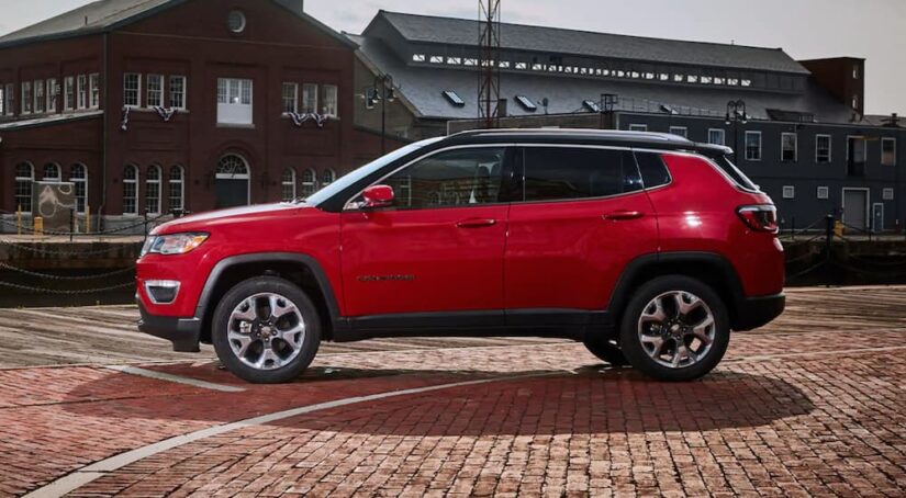 A side angle view of a red 2024 Jeep Compass.