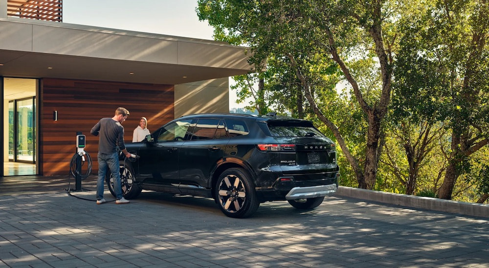 A black 2024 Honda Prologue is shown from the rear at an angle.