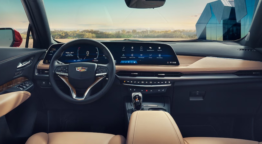 The tan interior of a 2024  Cadillac XT4 is shown from the driver's seat.