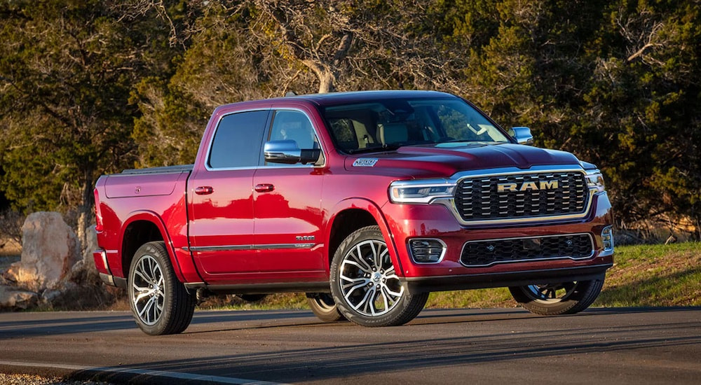 A red 2025 Ram 1500 is shown from the front at an angle.