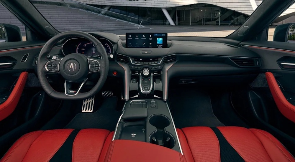 The red interior of a 2025 Acura TLX Type S is shown from above the center console.