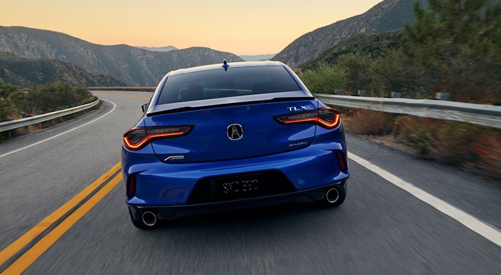 A blue 2025 Acura TLX A-Spec is shown from the rear.