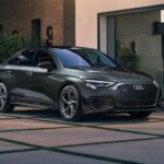 A gray 2024 Audi A3 is shown parked near a dealership.