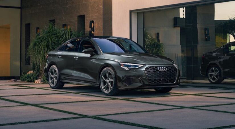 A gray 2024 Audi A3 is shown parked near a dealership.