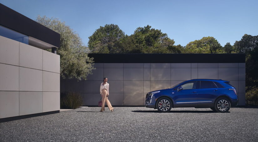 A blue 2024 Cadillac XT5 for sale is shown from the side.