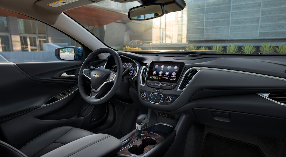 the black interior of a 2025 Chevy Malibu is shown from the passenger side.