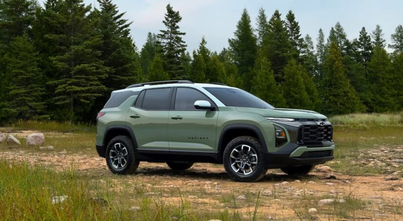 A green 2025 Chevy Equinox ACTIV parked in a field.