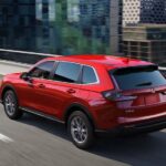 A red 2023 Honda CR-V is shown from the rear at an angle.